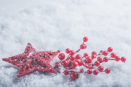 beautiful romantic vintage red heart with mistletoe berries on a white snow background. Christmas, love and St. Valentines Day concept.の写真素材
