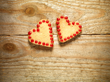 Gingerbread cookies hanging over wooden background, Christmas and Valentine&amp;#39;s Day concept.の写真素材