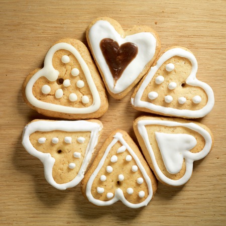 Gingerbread cookies hanging over wooden backgroundの写真素材