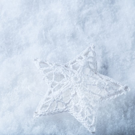 Beautiful star on a white frost snow backgroundの写真素材