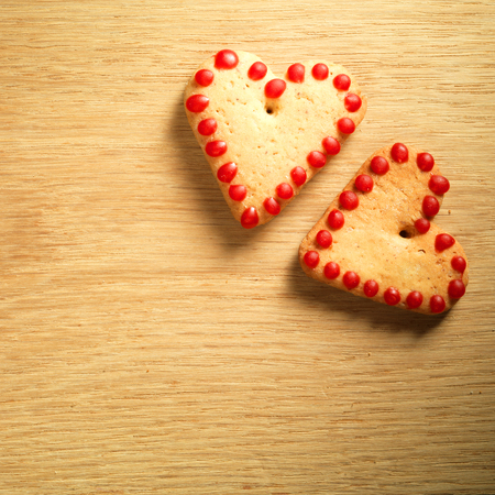 Gingerbread cookies hanging over wooden backgroundの写真素材