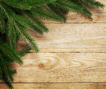 Christmas fir tree with decoration on a wooden board.の写真素材