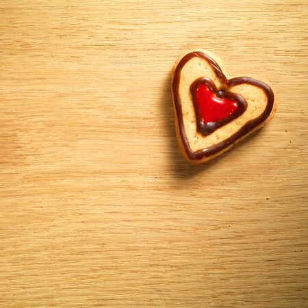 Gingerbread cookies hanging over wooden backgroundの写真素材