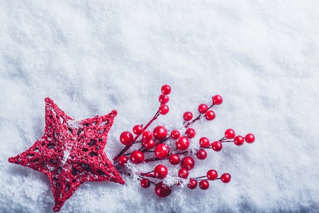 beautiful romantic vintage red heart with mistletoe berries on a white snow background.の写真素材