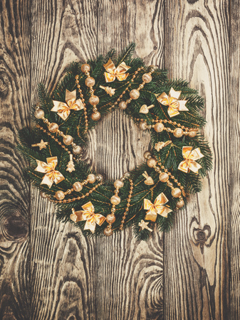 Christmas wreath on a rustic wooden front door.の写真素材