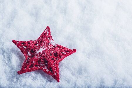 Beautiful magical vintage red star on a white snow background. Winter and Christmas conceptの写真素材
