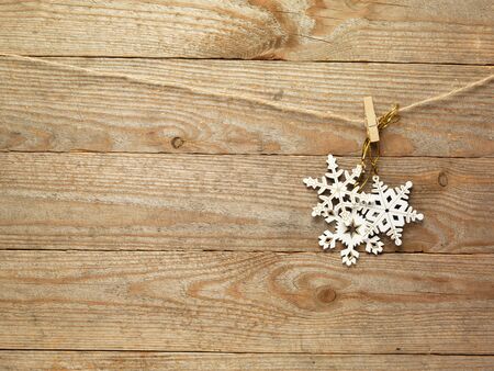 Gingerbread cookies and christmas decorations hanging over wooden background.の写真素材