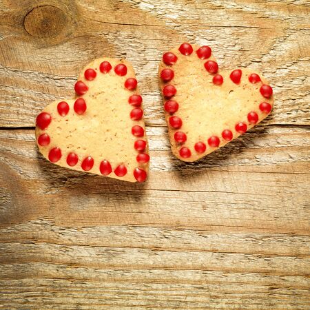 Gingerbread cookies hanging over wooden backgroundの写真素材