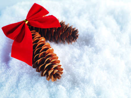 Beautiful sparkling silver and red Christmas decoration on a white snow background.の写真素材