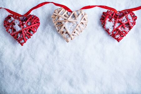 Beautiful romantic vintage hearts on a white frosty snow winter background. Love and St. Valentines Day concept.の写真素材