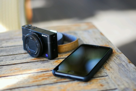 Sony camera and phone on the table.の素材