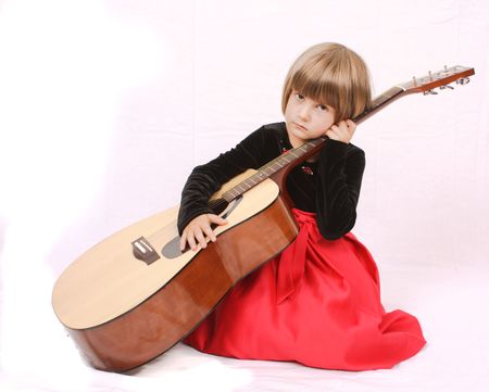 A little girl playing guitarの写真素材