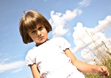 Little girl playing on grassの写真素材