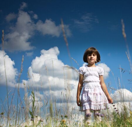 Little girl playing on grassの写真素材