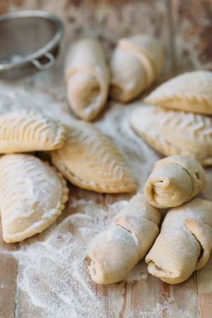 Roll cookies with nuts on a wooden table. Georgian dessert. Croissants, pastry rolls.の写真素材