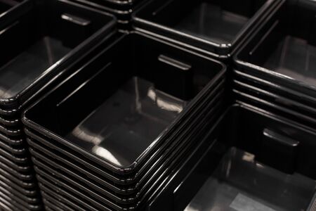 black plastic containers stack in a storeの写真素材