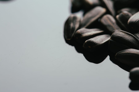 many black sunflower seeds background close up.の写真素材
