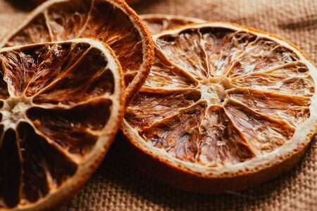 Dried lemon and orange on a light background sacking.の写真素材