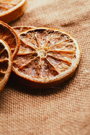 Dried lemon and orange on a light background sacking.の写真素材