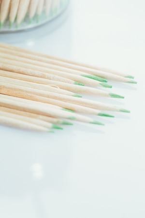 toothpicks with a green bordering on a white backgroundの写真素材