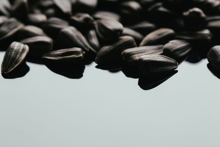many black sunflower seeds background close up.の写真素材