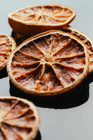 dry lemon and orange on a dark mirror background.の写真素材