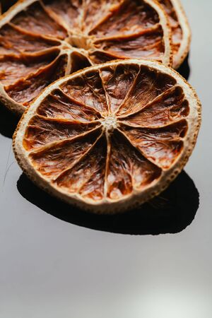 dry lemon and orange on a dark mirror background.の写真素材
