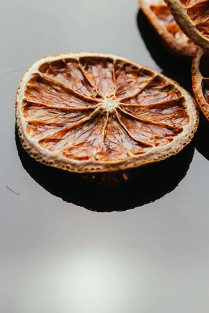 dry lemon and orange on a dark mirror background.の写真素材