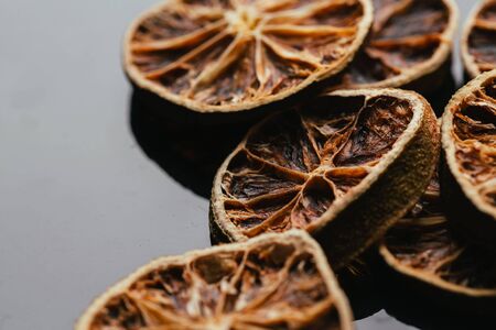 dry lemon and orange on a dark mirror background.の写真素材