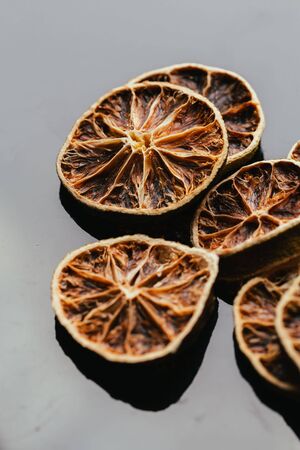 dry lemon and orange on a dark mirror background.の写真素材