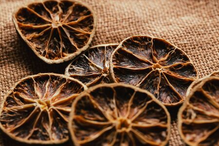 Dried lemon and orange on a light background sacking.の写真素材