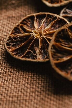 Dried lemon and orange on a light background sacking.の写真素材