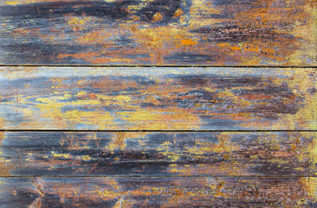 Old gray and yellow wooden background with cracks and scratches in vintage style