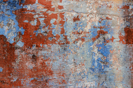 Texture of old rustic wall covered with blue and orange stucco