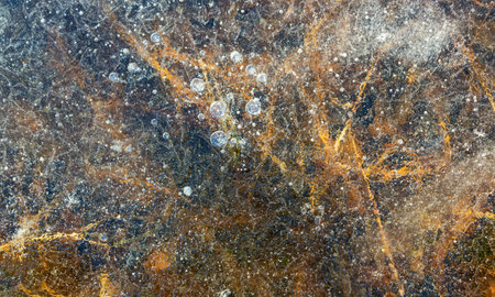 abstract background of a lake frozen with ice and bubbles in itの写真素材