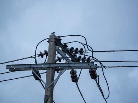 Electric pole,cables and blue sky background