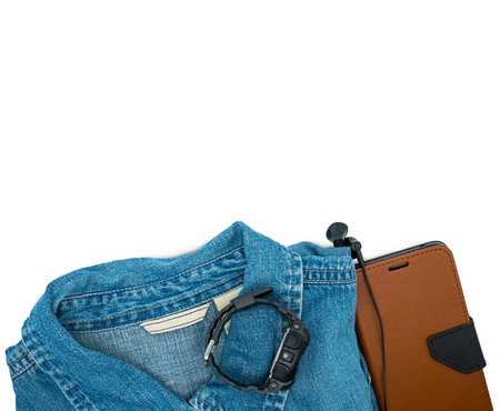 Top view blue jeans jacket,black watch,phone and earphones on white background with copy space Travel,lifestyle conceptの写真素材