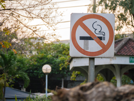 Smoking prohibit sign in the park on blurred backgroundの写真素材