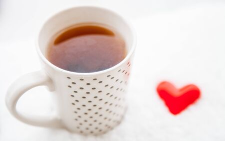 A cup of hot drink on the fresh snowの写真素材