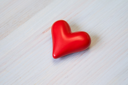Ceramic red heart on wooden backgroundの写真素材