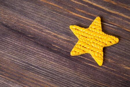 Beautiful yellow star on wooden backgroundの写真素材