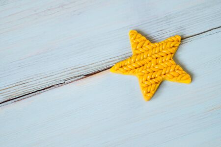 Beautiful yellow star on blue wooden backgroundの写真素材