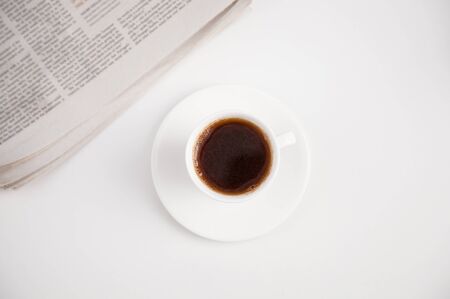 A cup of coffee on the table/workplaceの写真素材
