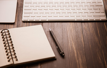 Opened notebook, keyboard on the table, workplace backgroundの写真素材