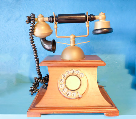 Old vintage telephone on blue backgroundの写真素材