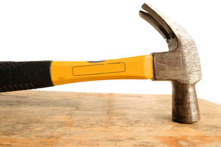 Carpenter is hum-mering a nail into a woodの写真素材