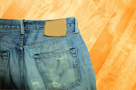 Blue jeans  on wooden backgroundの写真素材