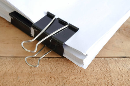 Black Paper clip on wooden backgroundの写真素材