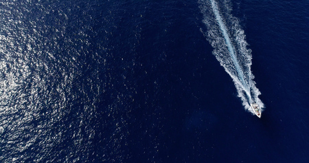 Boat at sea leaving a wake