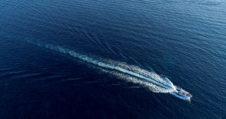 Boat at sea leaving a wake
